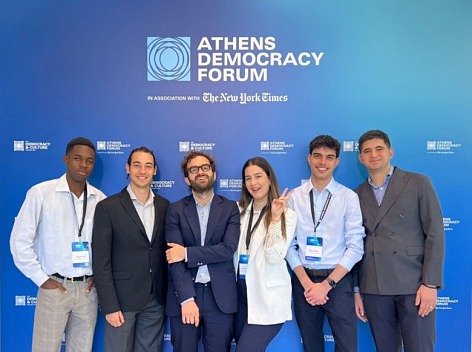 Pictured are Evina Walsh (BSI ’29), Angelos Varotsis (BSPSY ’28), Rafail Sideris (BM ’27) along with the Communications team of the Athens Democracy Forum.